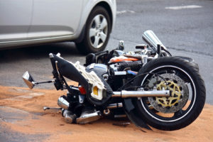 motorcycle lying sideways on roadway