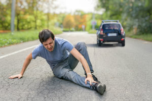 hit and run pedestrian injured foot as fleeing car drives away