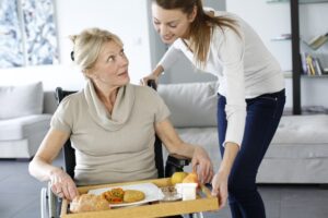 family member helping to feed meal to family member with TBI